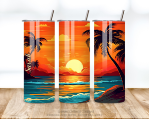 This photo shows the front, back, and side of beach sunset tumbler with golden tones and palm trees sitting on a table.